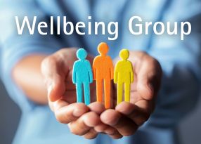 wooden people held in a cupped hand